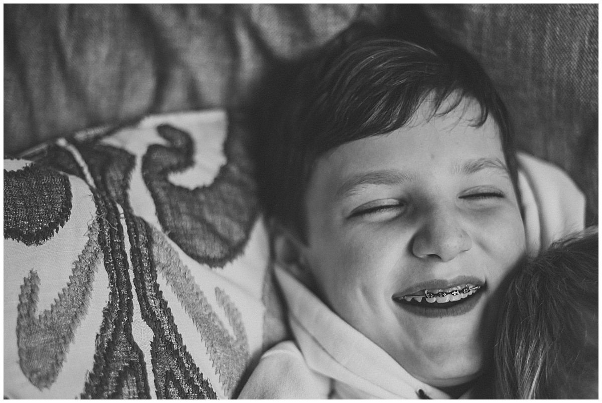 boy laying on a pillow laughing