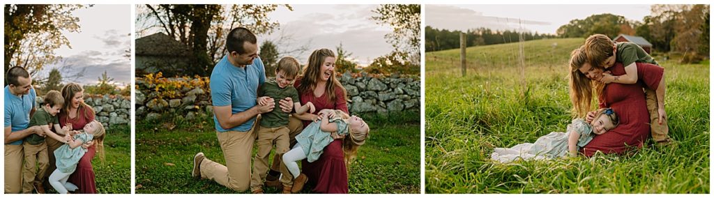 mother, father, daughter and son in a field laughing, smiling, tickling.