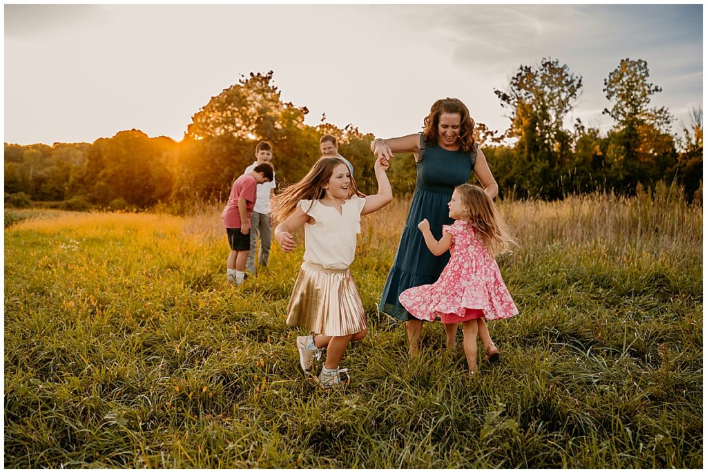 mother dancing with her daughters in a Boston photography location 
