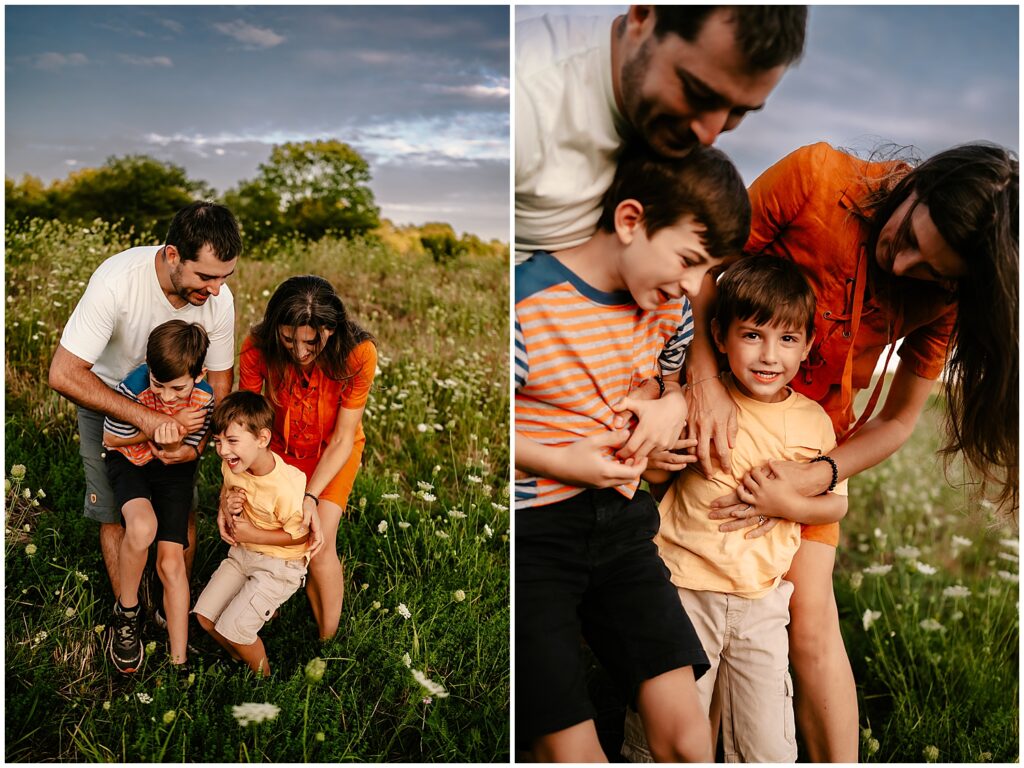 Mother, Father and two sons tickling and playing in a field 
