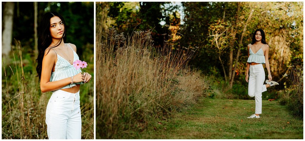 Hopkinton MA senior girl wearing white jeans and a blue tank top dancing in a field for her senior photos.