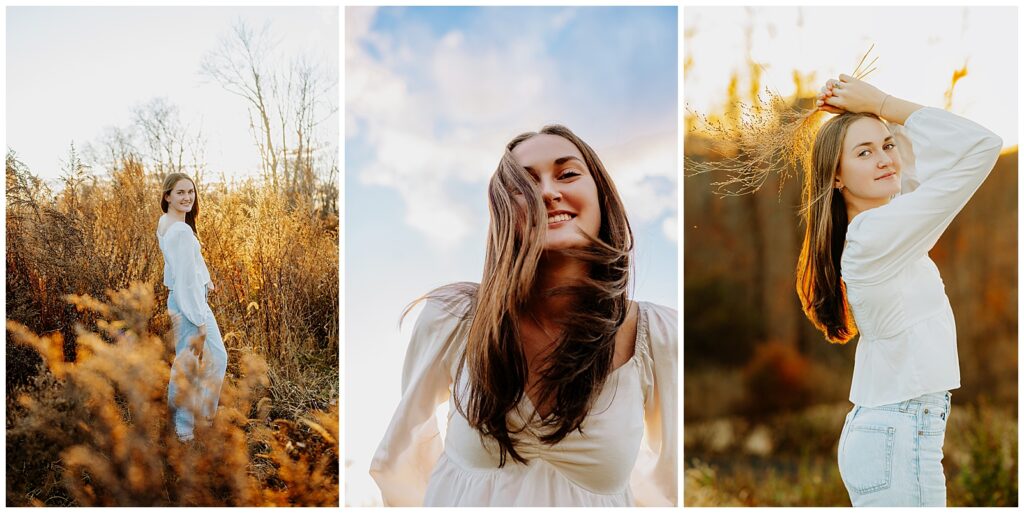 Girl with long brown hair wearing a white shirt and jeans standing in a field with the sun behind her.
