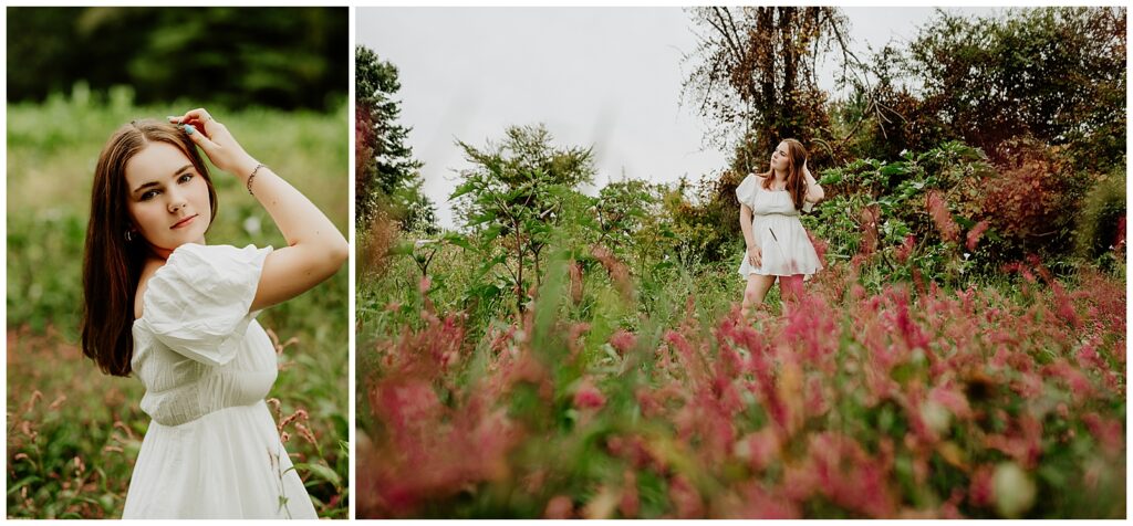 High school senior in a field wearing a white dress holding flowers over her head