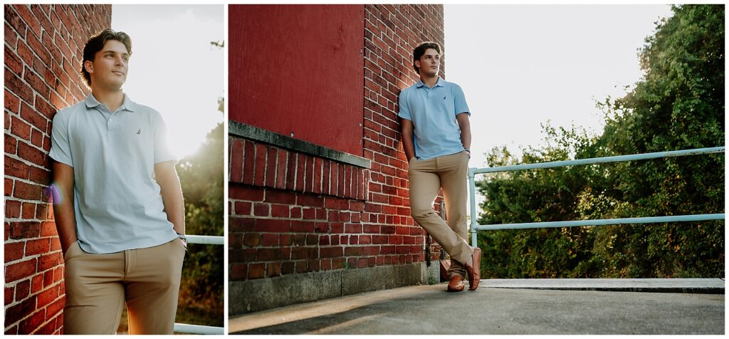 High School boy wearing tan pants and a blue polo shirt with his hands in his pockets. He is leaning against a brick wall. The sun is shining brightly behind him.