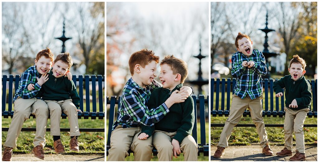 Two brothers with red hair sitting on a park bench making funny faces at each other.
