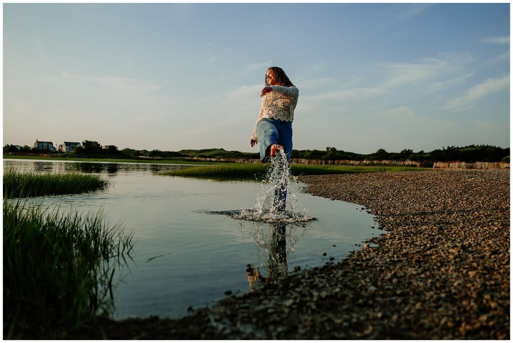 Senior girl kicking water at Rexhame Beach