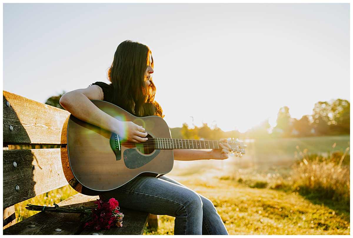 Hopkinton Senior session with a girl playing the guitar in an outdoor field.