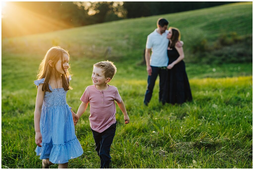 Family during a lifestyle family session smiling at camera during an outdoor session in MetroWest MA