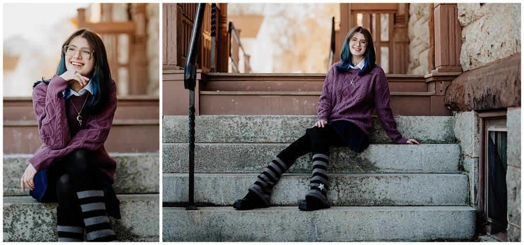 Senior girl with blue hair sitting and smiling on stone steps outside a historic building in downtown Milford.